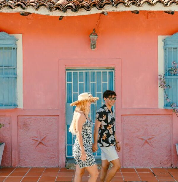Travelers exploring colorful colonial streets during a cultural city tour in Colombia