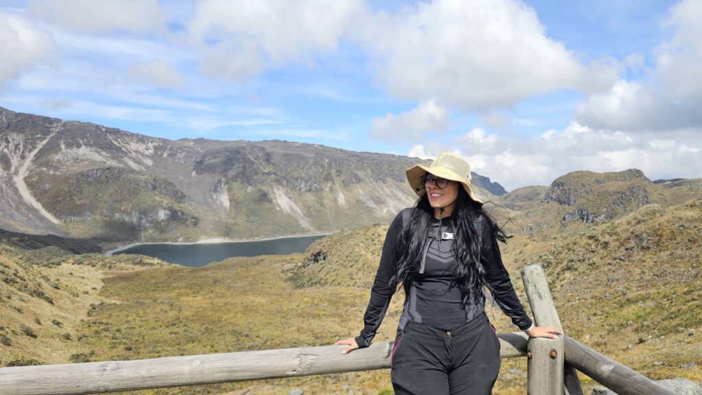 Female hiker overlooking Laguna Verde during an acclimatization hike in Los Nevados National Natural Park, Colombia.