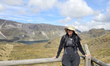Female hiker overlooking Laguna Verde during an acclimatization hike in Los Nevados National Natural Park, Colombia.