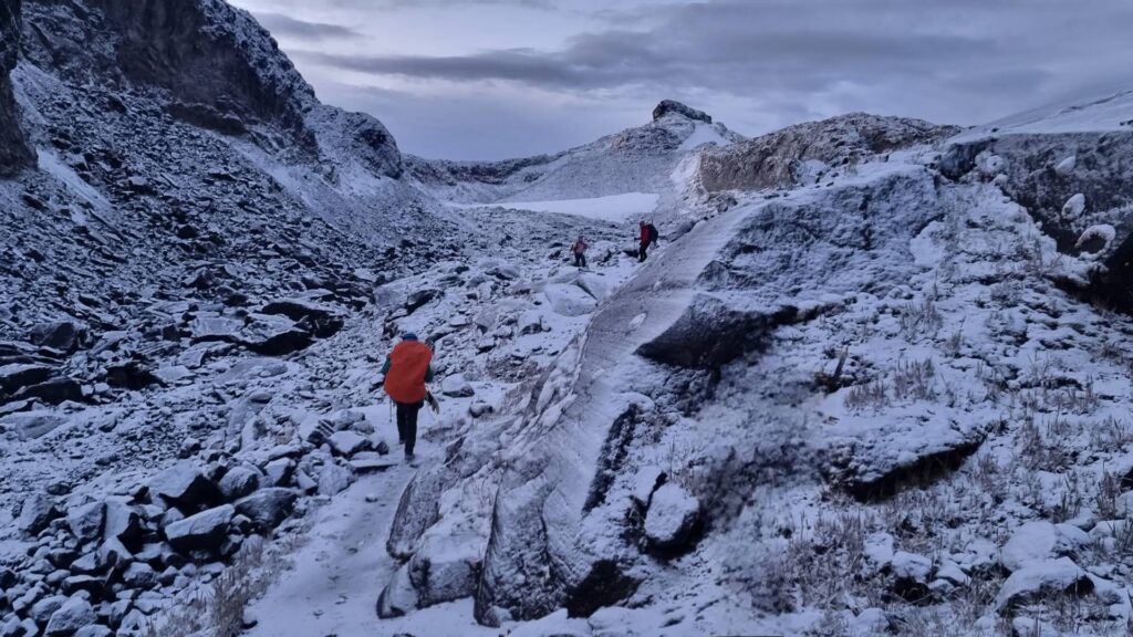 Hikers approaching the Conejeras Glacier (now extinct) on Nevado Santa Isabel in Los Nevados National Natural Park, Colombia.