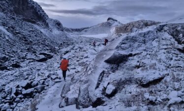 Hikers approaching the Conejeras Glacier (now extinct) on Nevado Santa Isabel in Los Nevados National Natural Park, Colombia.