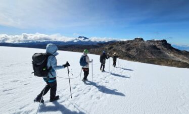 Travelers hiking roped together across the Nevado Santa Isabel glacier during a guided glacier trek in Los Nevados National Natural Park, Colombia